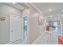 Inviting hallway with modern light gray wood flooring and neutral wall color at 4680 Peppertree St, Pahrump, NV 89061