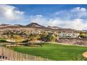 View of golf course and mountain view from the backyard fence of this property at 5 Mountain Cove Ct, Henderson, NV 89052
