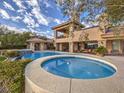 Beautiful pool with spa and landscaping in a luxury backyard at 5 Mountain Cove Ct, Henderson, NV 89052