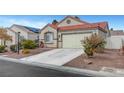 Inviting single-story home with a desert landscape front yard and a spacious driveway leading to a two-car garage at 514 Regal Robin Way, North Las Vegas, NV 89084