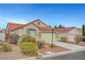 Well-kept single-story home showcasing desert landscaping, a driveway, and a two-car garage, all beneath a clear blue sky at 514 Regal Robin Way, North Las Vegas, NV 89084