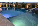 Sparkling pool with subtle underwater lighting and convenient entry steps, nestled in a private backyard oasis at 5371 Brevin Ct, Las Vegas, NV 89131