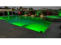 Backyard pool featuring radiant green underwater lighting, enhancing the outdoor living space at 5371 Brevin Ct, Las Vegas, NV 89131