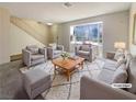 Bright living room with cozy seating arrangement, large window, and neutral decor, ideal for relaxation and entertaining at 5383 Mountain Vista St # 20, Las Vegas, NV 89120