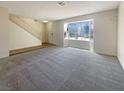 Spacious living room with plush carpet, a large window, and neutral paint, creating a versatile and welcoming atmosphere at 5383 Mountain Vista St # 20, Las Vegas, NV 89120