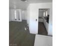 Living room with an open floor plan featuring gray floors and white walls at 5580 E Carey Ave, Las Vegas, NV 89156