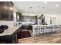 Modern kitchen with stainless steel appliances, pendant lighting and a large island with bar seating at 6225 Gambetta St, Las Vegas, NV 89115