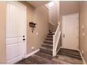 Inviting entryway with wood-look floors and a staircase leading to the upper level at 6308 Gulf Waters St, North Las Vegas, NV 89081