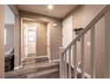 Hallway featuring wood-look flooring, a staircase, and neutral wall paint at 6308 Gulf Waters St, North Las Vegas, NV 89081