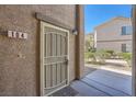 Charming front door entrance with security screen door and visible unit number at 6745 Caporetto Ln # 104, North Las Vegas, NV 89084