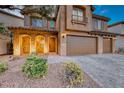 Charming home with stone archway, three-car garage, desert landscaping, and a brick driveway at 7479 Lassen Peak Cir, Las Vegas, NV 89149
