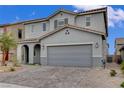 This beautiful two-story home features a 2-car garage and a paver driveway at 7532 Lush Oasis Ave, Las Vegas, NV 89113
