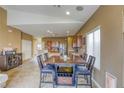 Cozy dining area with a wooden table, seating for six, and a bar for entertaining guests at 9432 Victory Garden Ave, Las Vegas, NV 89149