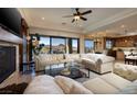 Spacious living room with plush sofas, a fireplace, and scenic views at 10 Via Potenza Ct, Henderson, NV 89011
