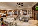 Open-concept living room features a cozy seating area and a clear view to the kitchen at 10 Via Potenza Ct, Henderson, NV 89011