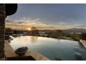 Luxury infinity pool with scenic mountain views at sunset at 10 Via Potenza Ct, Henderson, NV 89011