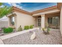 Inviting front entrance with desert landscaping, a tiled walkway, and charming curb appeal at 10401 Sea Palms Ave, Las Vegas, NV 89134