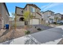 Exterior of a two-story stucco home with a paved driveway and manicured rock garden at 10619 Carnes Ave, Las Vegas, NV 89166