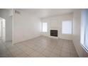 Open living room with tile floors, fireplace, and natural light from multiple windows at 1704 N Jones Blvd, Las Vegas, NV 89108