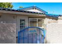 Home exterior with blue tile roof, gated entrance, and address plaque on gate at 2109 Willowbury Dr # C, Las Vegas, NV 89108