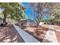 Desert landscaping surrounds this single story home with sidewalks and mature trees at 2109 Willowbury Dr # C, Las Vegas, NV 89108