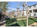 Exterior view of common community green space with picnic tables and walkways at 2846 Cerulean Stars Ln # 1, Las Vegas, NV 89183