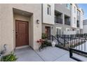 A view of townhome exteriors with patios, showcasing modern architectural details and landscaping at 2846 Cerulean Stars Ln # 1, Las Vegas, NV 89183