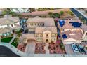 Expansive aerial view of a two-story home showcasing its spacious driveway and landscaping at 2908 Ferrand Ct, Henderson, NV 89044