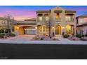 Stunning two-story home featuring an arched portico, balcony, and beautifully landscaped front yard at 2908 Ferrand Ct, Henderson, NV 89044