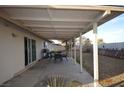 Covered patio with outdoor dining set perfect for entertaining in the spacious backyard at 301 Falcon Ln, Las Vegas, NV 89107