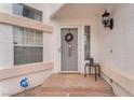 Close up of front door with welcome wreath, outdoor light fixture, and small bistro set at 3609 Twinbreeze St, Las Vegas, NV 89129