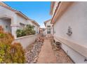A view of the landscaped side yard, featuring drought-tolerant plants and stone walkways at 3609 Twinbreeze St, Las Vegas, NV 89129