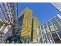 Modern high-rise building featuring a unique yellow tiled design with a glass enclosed entry and architectural detail at 3722 Las Vegas Blvd # 2001, Las Vegas, NV 89158