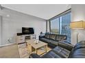 Cozy living room with comfortable leather seating, stylish decor, and a large window offering a cityscape view at 3722 Las Vegas Blvd # 2001, Las Vegas, NV 89158