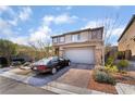 Stunning two-story home featuring a desert landscape and a spacious two-car garage at 397 American Dipper St, Las Vegas, NV 89138
