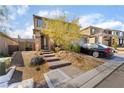 Inviting two-story home boasting a desert landscape, brick steps, and a two-car garage at 397 American Dipper St, Las Vegas, NV 89138