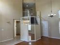 Bright living room with wood floors, a two story window, and staircase at 417 Raindance Dr, Henderson, NV 89014