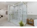Spacious bathroom features a large glass shower with dual shower heads and elegant marble tile at 5225 Villa Dante Ave, Las Vegas, NV 89141