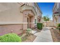 Inviting townhome entrance featuring well-manicured landscaping at 5537 Parlay Way # 101, Las Vegas, NV 89122