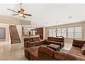 Spacious living room showcasing a tile floor, staircase, neutral walls, and open kitchen bar at 5809 Sagamore Canyon St, North Las Vegas, NV 89081