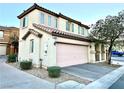Beautiful two-story home with a two-car garage, desert landscaping and a stucco exterior at 6087 Devers Ct, Las Vegas, NV 89118