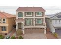 Two-story home featuring a brick and stone facade, a two-car garage, a tiled roof and a well-manicured front yard at 6346 Rock Strm Ln, Las Vegas, NV 89141