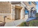 Inviting townhome entrance, featuring a neutral color scheme, well-kept garden and a covered entryway at 6637 Lookout Lodge Ln # 1, North Las Vegas, NV 89084