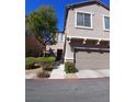 Two story home featuring an attached 2 car garage and desert landscaping at 684 Calamus Palm Pl, Henderson, NV 89011