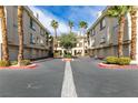 Well maintained condominium complex courtyard with mature palm trees and ample parking at 7163 S Durango Dr # 302, Las Vegas, NV 89113