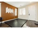 Bright room with a large window, hard wood floor, and wall decorations at 7214 Regent Pond St, Las Vegas, NV 89166