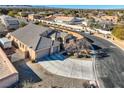 Lovely single-story home showcasing a spacious driveway, two-car garage, and beautiful landscaping at 7711 Gracemoor Ct, Las Vegas, NV 89149
