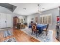 Formal sitting and dining area with hardwood floors and a large window at 8817 Adobe Grande St, Las Vegas, NV 89131