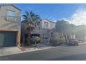 View of a two-story home with an attached garage, private balcony, and desert landscaping at 9078 Hilverson Ave, Las Vegas, NV 89148