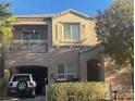 This two-story home features an attached garage, covered entry, and a private balcony at 9078 Hilverson Ave, Las Vegas, NV 89148